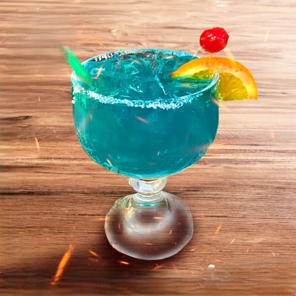 Blue margarita with a salted rim, orange slice, cherry, and green straw on a wooden table.